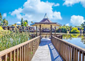 Thumbnail 8 of 9 - a wooden bridge leading to a gazebo on the water