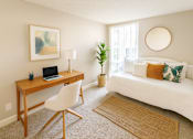 Thumbnail 4 of 9 - A room with a desk, chair, and bed.