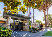 Thumbnail 1 of 4 - The image shows the entrance to Lakeshore Apartments with a gate and a signboard.