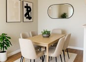 Thumbnail 2 of 8 - A dining room with a table, chairs, and a ceiling fan.