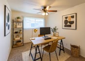 Thumbnail 4 of 10 - A room with a desk and a chair.