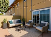 Thumbnail 6 of 10 - A patio with a sofa, two chairs and a table with a plant on it.
