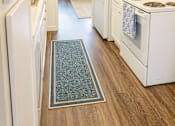 Thumbnail 3 of 9 - A kitchen with white appliances and a blue rug on the floor.