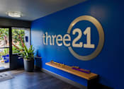 Thumbnail 8 of 9 - a blue wall with the logo of three 21 on it