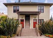 Thumbnail 8 of 10 - a house with red doors and a staircase