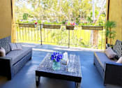 Thumbnail 4 of 8 - A patio with a table and chairs overlooking a tree-filled yard.