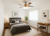 Thumbnail 5 of 13 - A bedroom with a bed, desk, and chair.