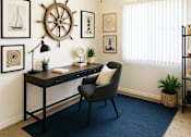 Thumbnail 4 of 13 - A room with a desk, chair, and a ceiling fan.