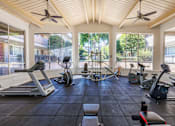 Thumbnail 10 of 13 - A spacious gym with treadmills, exercise bikes, and elliptical machines.