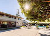 Thumbnail 8 of 9 - A sunny day at the apartment complex with a pool in the background.