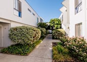 Thumbnail 6 of 9 - A white building with a blue door number 28.