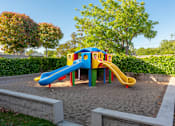 Thumbnail 5 of 8 - A colorful playground with a blue and yellow slide.