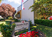Thumbnail 1 of 7 - A sign for Amador Heights Apartments is in front of a building.