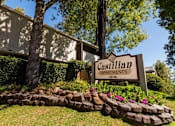 Thumbnail 1 of 9 - A sign for Castilian Apartments is in front of a building.