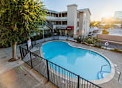 Thumbnail 5 of 5 - A small pool surrounded by a black fence.