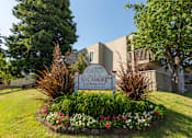 Thumbnail 1 of 8 - A sign that says Sycamore Commons in front of a building.
