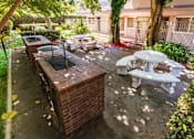 Thumbnail 7 of 9 - a patio with a barbecue grill and tables