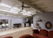 Thumbnail 9 of 9 - a living room with a ceiling fan and a kitchen