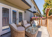 Thumbnail 6 of 11 - a patio with wicker chairs and a table on a patio