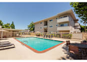Thumbnail 4 of 8 - A large house with a pool in the backyard.