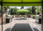 Thumbnail 10 of 10 - A green umbrella is in the middle of a patio.