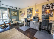 Thumbnail 5 of 10 - A living room with a flat screen TV and a wooden cabinet.