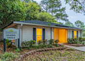Thumbnail 1 of 8 - A small house with a sign that says "Summer Place Leasing Office".