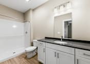 Thumbnail 5 of 8 - a bathroom with a sink and a toilet and a window