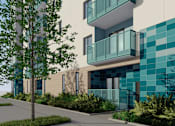 Thumbnail 1 of 14 - A modern building with a blue tiled wall and a tree in front.