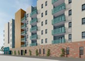 Thumbnail 3 of 14 - A modern apartment building with balconies and a brick wall in front.