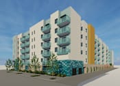 Thumbnail 14 of 14 - A modern apartment building with balconies and a blue and yellow facade.