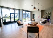 Thumbnail 7 of 47 - a living room with chairs and a coffee table and large windows