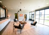 Thumbnail 6 of 47 - a large living room with large windows and a table and chairs