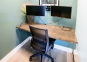 Thumbnail 39 of 47 - a home office with a desk and two monitors