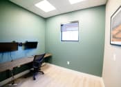 Thumbnail 41 of 47 - a room with a desk and a monitor and a window