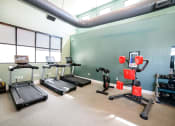 Thumbnail 34 of 47 - a gym with treadmills and other exercise equipment in the wellness center