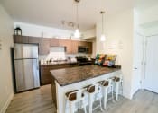 Thumbnail 13 of 47 - an open kitchen with stainless steel appliances and a granite counter top