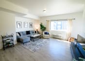 Thumbnail 20 of 47 - a living room with a couch and a tv