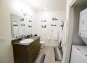 Thumbnail 29 of 47 - a bathroom with a sink and a toilet and a large mirror