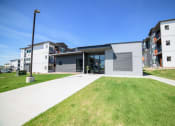 Thumbnail 3 of 47 - a view of a building with a lawn in front of it