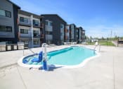 Thumbnail 45 of 47 - a swimming pool with an apartment building in the background