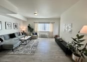 Thumbnail 22 of 47 - a living room with a couch and a table