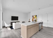 Thumbnail 10 of 63 - a kitchen and living room with white walls and wood floors at The Franklin Marlboro Apartments, Marlboro, NJ