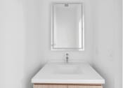 Thumbnail 17 of 63 - A white sink with a silver faucet and a mirror above it at The Franklin Marlboro Apartments, Marlboro, NJ 07746