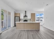 Thumbnail 15 of 63 - A modern kitchen with a wooden island and stainless steel appliances at The Franklin Marlboro Apartments, Marlboro, NJ 07746