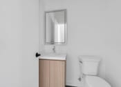 Thumbnail 27 of 63 - a bathroom with a toilet sink and a mirror at The Franklin Marlboro Apartments, New Jersey, 07746