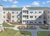 Thumbnail 3 of 11 - an exterior view of an apartment building with a courtyard at The Franklin at Hillsborough Apartments, NJ,08844