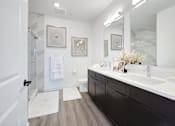 Thumbnail 10 of 11 - a white and black bathroom with a shower and sink at The Franklin at Hillsborough Apartments, NJ,08844