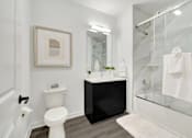 Thumbnail 9 of 11 - a bathroom with a shower toilet and a sink at The Franklin at Hillsborough Apartments, Hillsborough, NJ