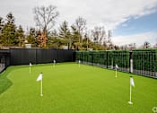 Thumbnail 35 of 63 - A golf course with green grass and white flags.
